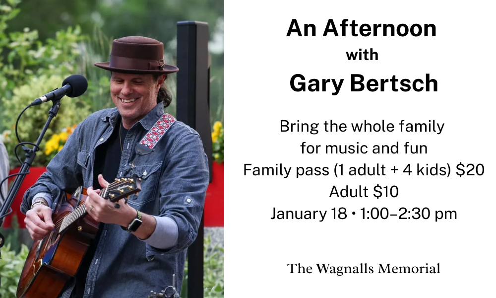 Smiling man playing a guitar outside